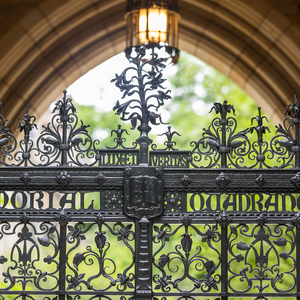 The intricate, wrought iron gate of the Memorial Quadrangle features the Yale motto Lux et Veritas and coat of arms